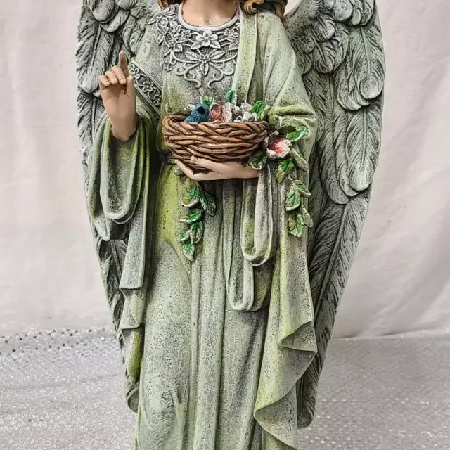 Angel holding a basket with a blue bird